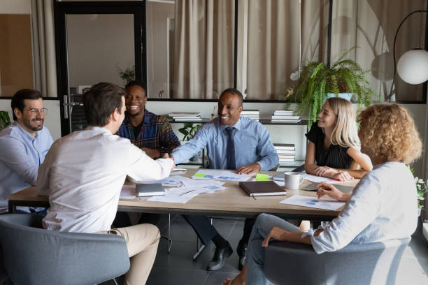 istock Smiling diverse business partners handshake in office 1337424356
