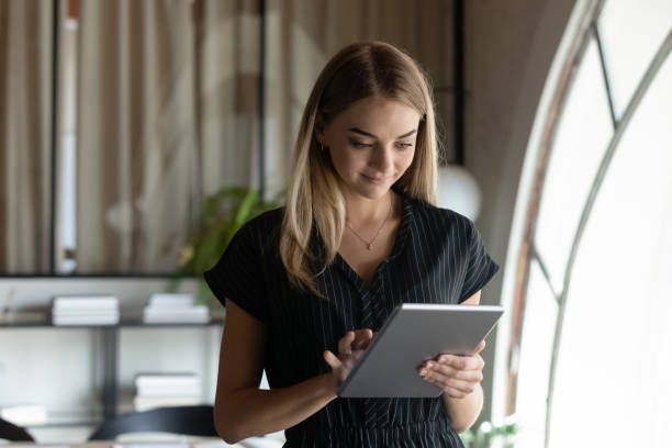 istock Young Caucasian businesswoman use tablet communicate online 1337424367