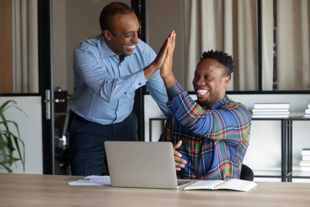 istock Happy ethnic colleagues give high five in office 1337424385