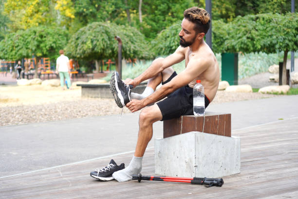 istock Athlete man changing clothes after the outdoors training 1337424451