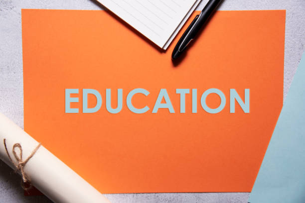 istock Education text on orange and baby blue background flat lay concept. 1337426678