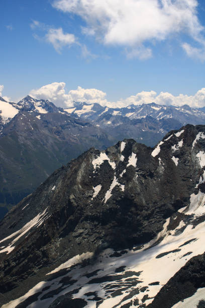 istock Snowcapped rocky summit at altitude in alps. 1337427236