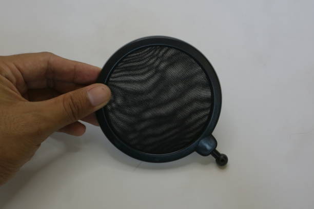 istock Black color of microphone pop filter on white isolated background photo 1337428726