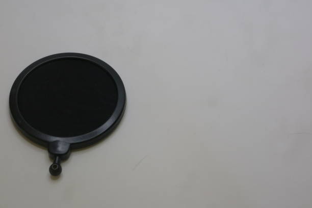 istock Black color of microphone pop filter on white isolated background photo 1337428820