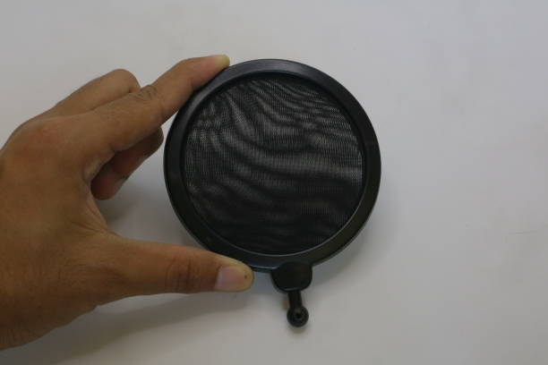 istock Black color of microphone pop filter on white isolated background photo 1337428878