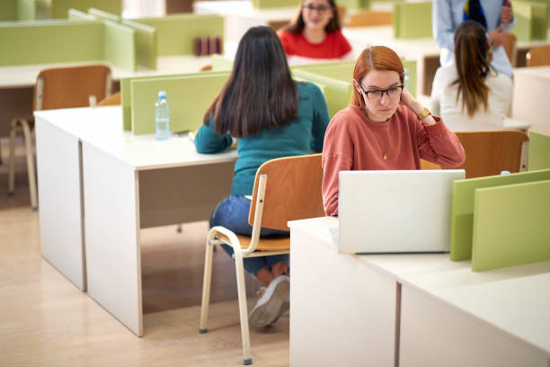 istock Female student working on a laptop at a lecture 1337429941