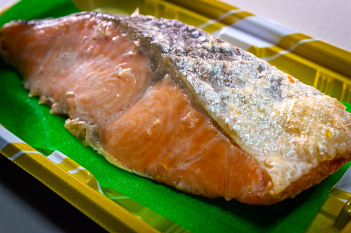 Closeup Japanese style Salmon Grilled with Salt (Shio Sake, or Shio Shake) sold by local supermarket in Japan. The Salmon Sake Fish (Sake or Shake in Japanese) in image on the plastic food container