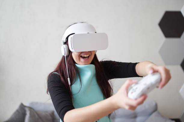 istock Woman with virtual reality headset is playing game. 1337430535