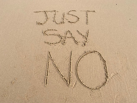 The words just say no written in the sand on a beach