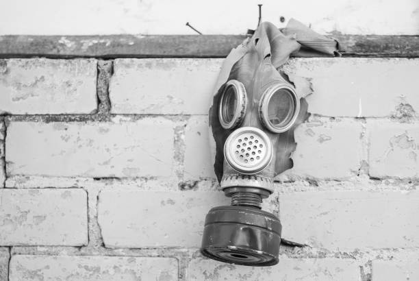 istock Old gas mask with coal filter hung on the brick wall. Black and white. Concept - Nuclear Disarmament and Radiation Protection, epidemic, coronavirus, covid-19, pandemic 1337431702