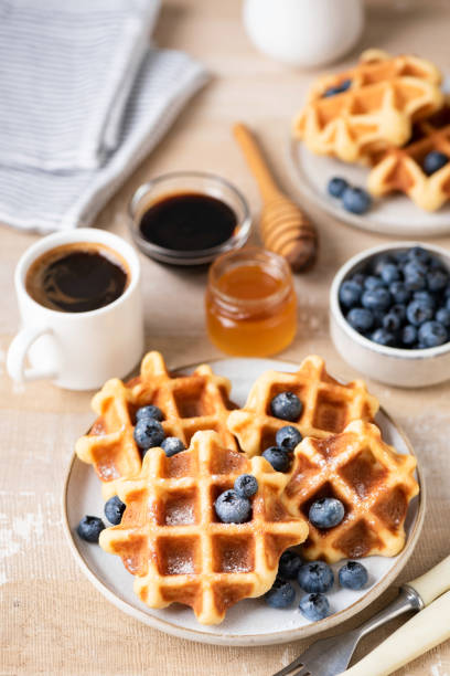istock Breakfast waffles with blueberries, honey and coffee 1337432211