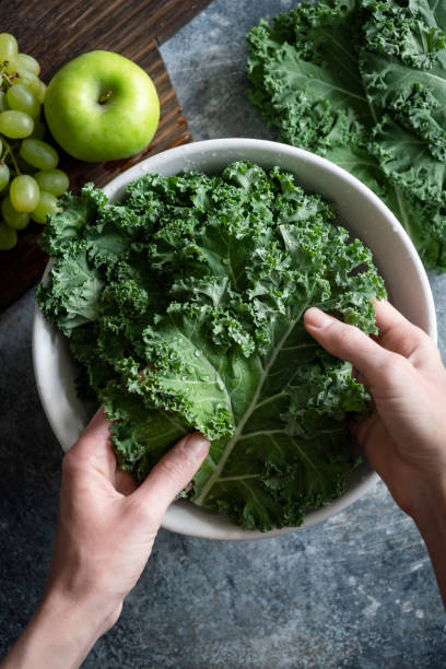 Woman washing kale cabbage leaf