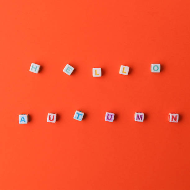 istock Text or inscription hello autumn. Cubes with letters on an orange background with copyspace 1337433032