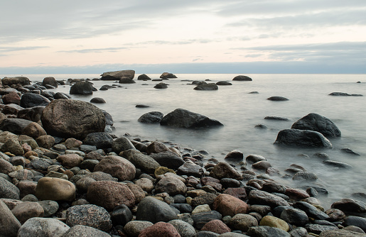 Seaside with big stones, long exposure photo