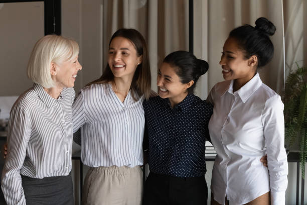 istock Happy diverse colleagues employees hugging, having fun, standing in office 1337433800