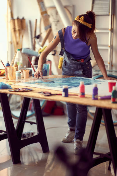 istock Cute female painter artist creating a new piece 1337435524