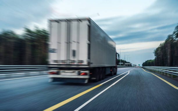 istock Truck on a highway in the night 1337435905