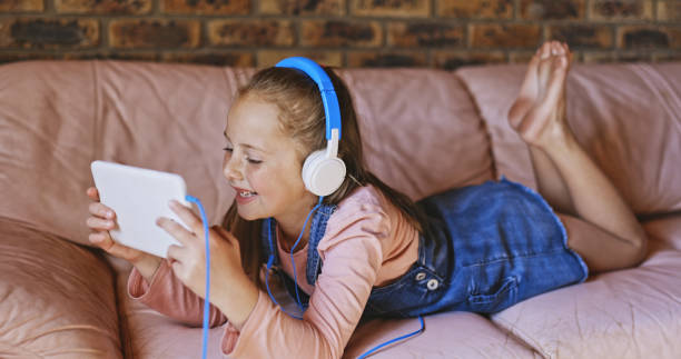 istock Shot of a little girl relaxing while using her digital tablet 1337438766