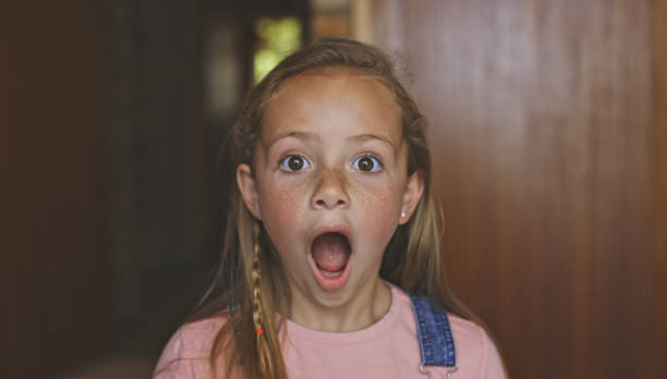 Shot of a young girl looking shocked stock photo