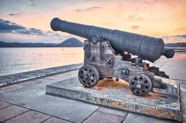 cañón largo español, antigua pieza de artillería en el paseo marítimo de la villa de santoña, españa - cannon spanish culture bronze weapon fotografías e imágenes de stock