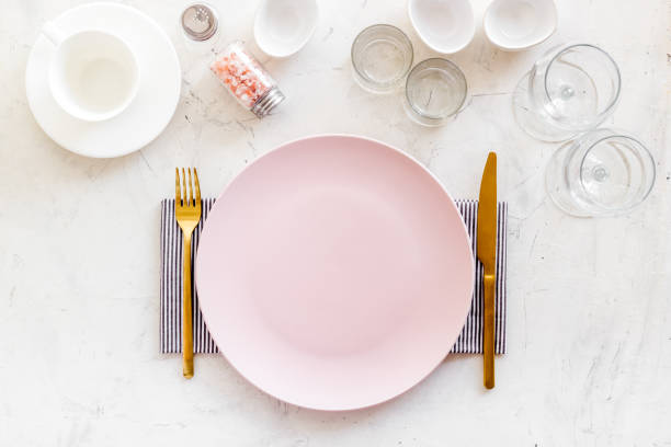 istock Dinner plate setting with cutlery and napkin. Top view 1337442519