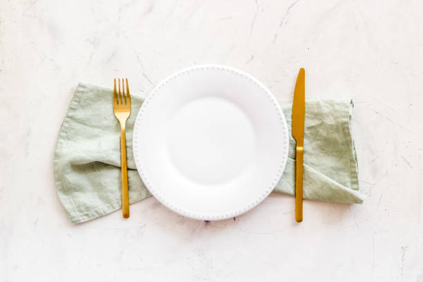 istock Dinner plate setting with cutlery and napkin. Top view 1337442729