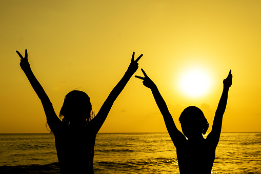 Young woman enjoying and feeling happy freedom at the sunset beach.