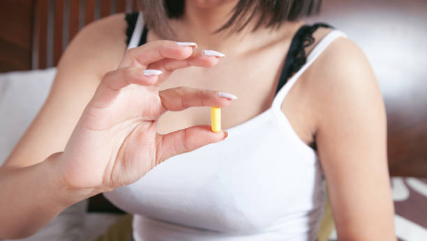 istock Young woman holding pill on bedroom. 1337443858