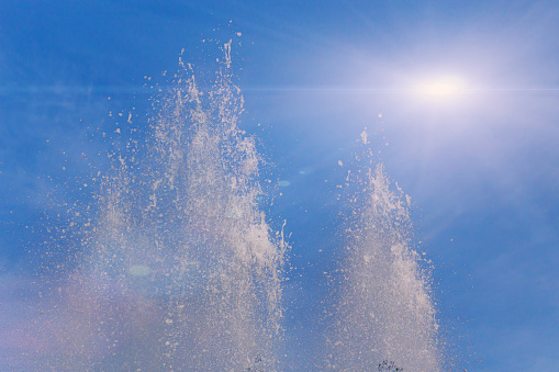 Fountain bursts and sunshine. Travel. Toned Background
