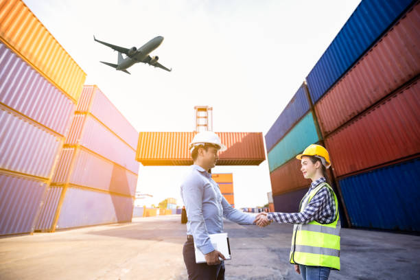 istock American Businessman and foreman women shake hands teamwork and checking at site container warehouse concept 1337444488