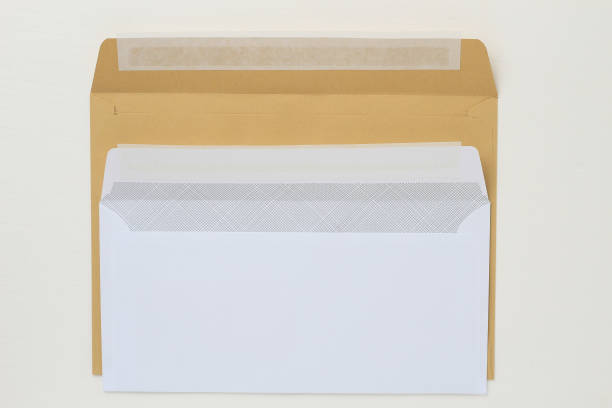 istock Two classic paper envelope on a white wooden table. Blank space 1337444520