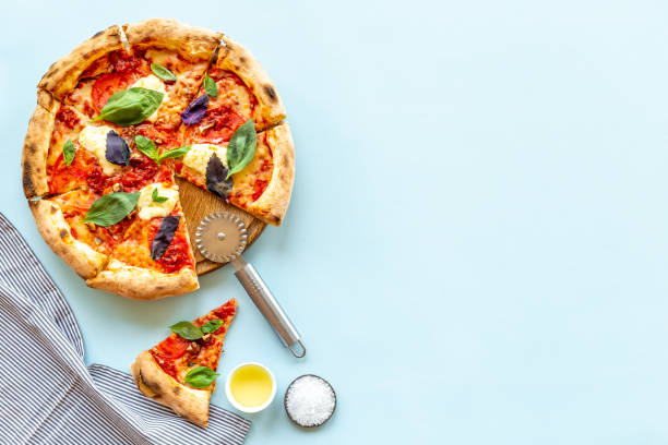 istock Pizza slices with tomatoes cheese and basil, top view 1337448071