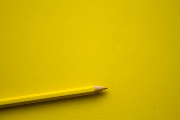 istock Yellow pencil on yellow background 1337451060
