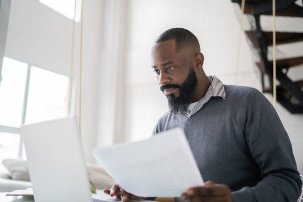istock Mid adult man doing home finances using laptop at home 1337451895