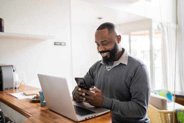 istock Man working at home using laptop and smartphone 1337451983
