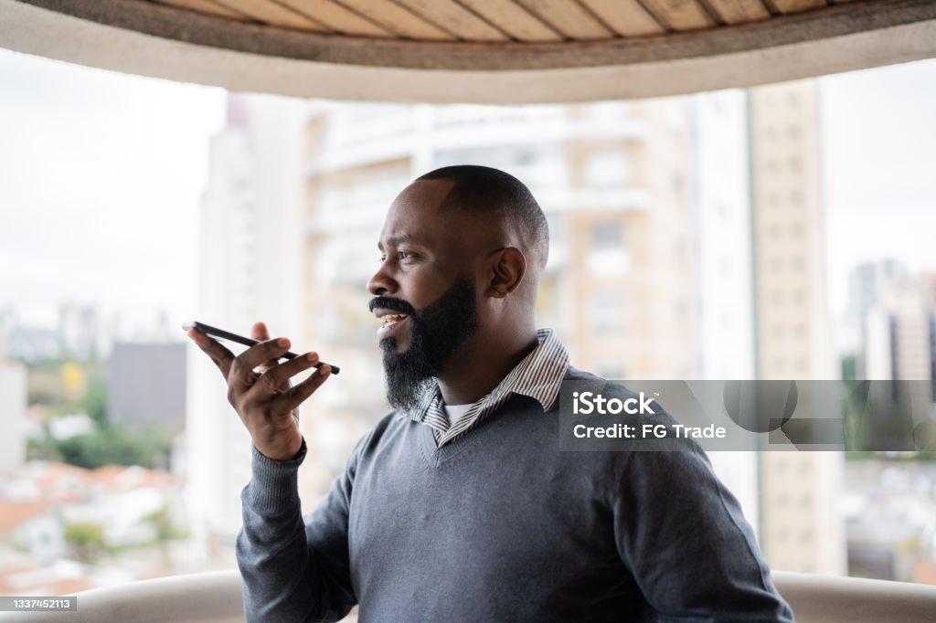 Man sending audio message on smartphone Telephone Stock Photo