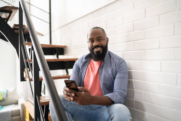 istock Portrait of a man using smartphone at home 1337452186