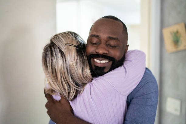 istock Happy couple embracing at home 1337452205