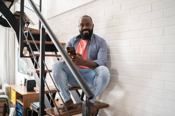 istock Portrait of a man using smartphone at home 1337452385