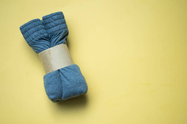 istock Rolled folded men boxer briefs with brown paper on a yellow background 1337453401