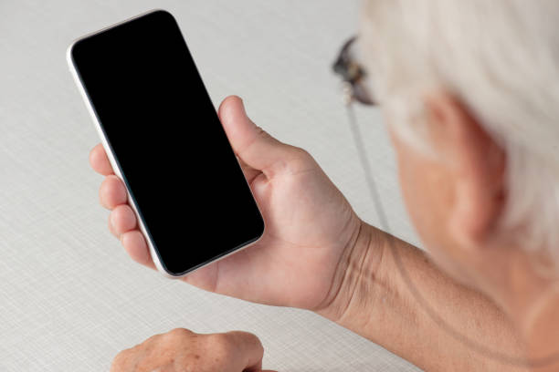 istock Senior Woman Looking Smart Phone 1337456051
