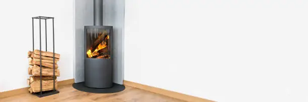 Photo of Modern wood burning stove. Panoramic contemporary home interior in winter