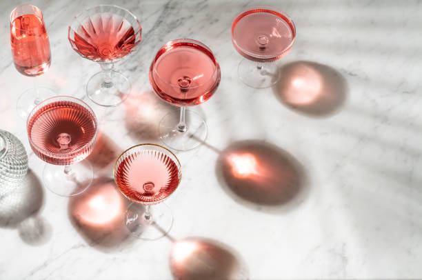 istock Pink Rose cocktail or mocktail with sunny summer light on white marble 1337460111