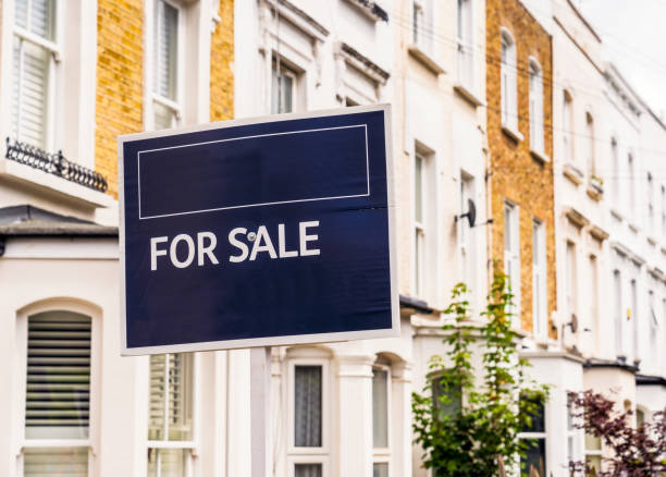 For Sale Sign in London A real estate agent For Sale sign on a residential street in Islington, London. house uk row house london england stock pictures, royalty-free photos & images