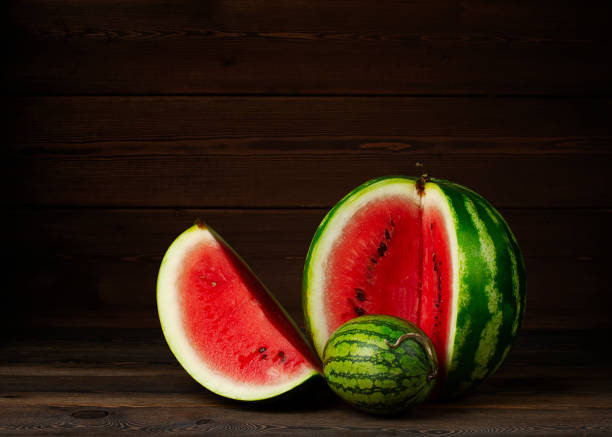 istock Mini watermelon, small, with a large cut, on a wooden table, no people, 1337463543