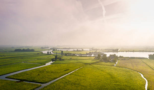 istock Sunrise above Typical Dutch polder landscape with windmills and meadows 1337463988
