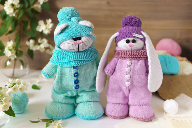 istock Toy knitted on wooden table. Crochet stuffed animals. 1337464040