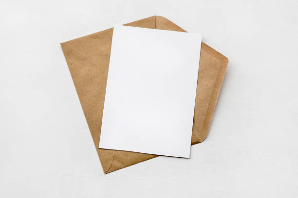istock An envelope made of kraft paper and a white blank card on a white table. Blank or empty postcard. 1337465670
