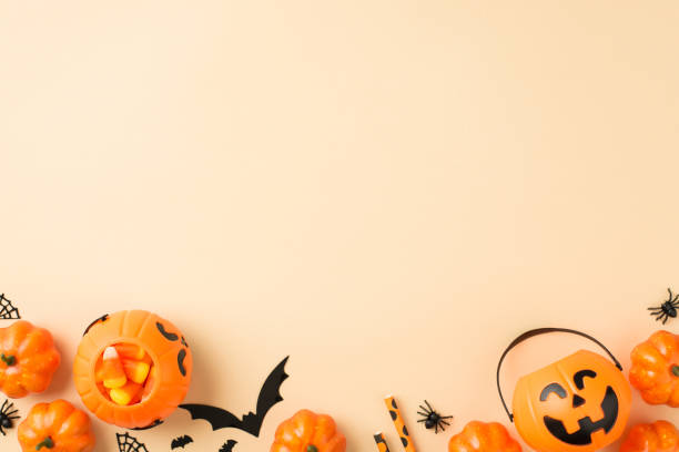 istock Top view photo of halloween decorations pumpkin baskets candy corn straws spiders web and bats silhouettes on isolated beige background with empty space 1337467726