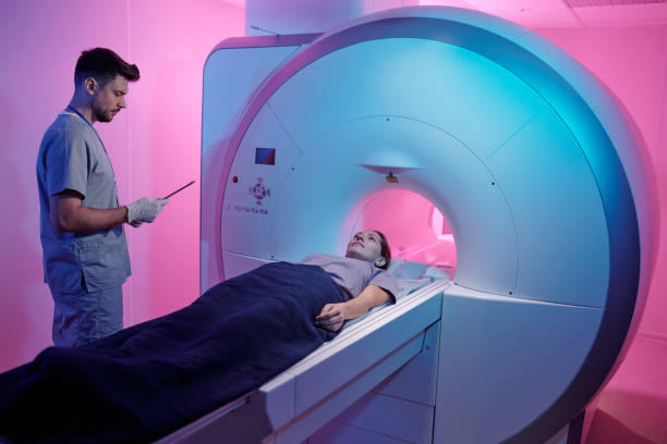 istock Young patient covered with towel lying on mri scan machine table 1337470110